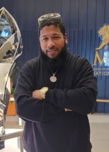 A man is posing with his arms crossed